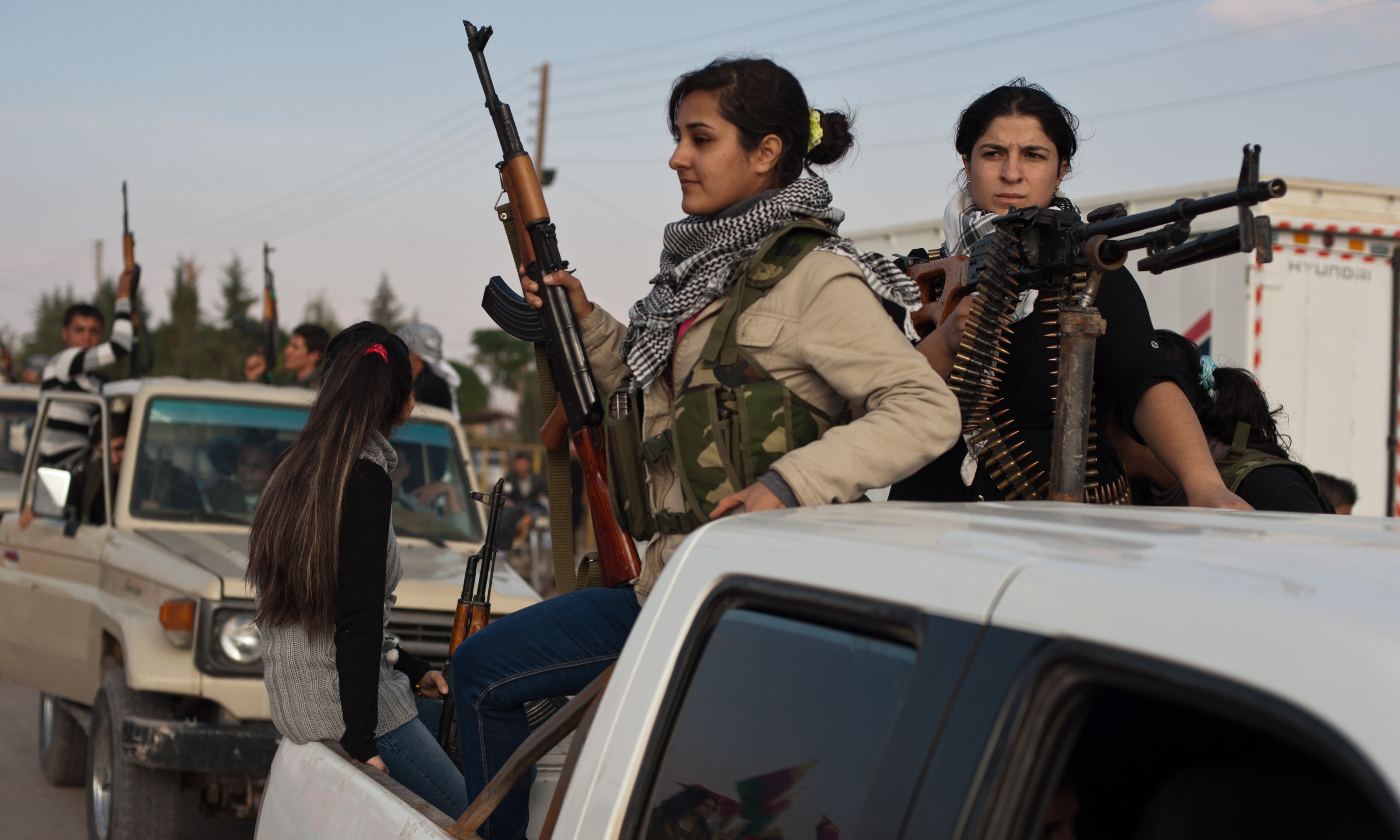 Kurdish anti-Syrian government activists parade the streets in celebration for the official declaration of liberation of the city of Derik, near al-Malikiyah, on November 15, 2012. (Photo credit should read Giulio Petrocco/AFP/Getty Images)