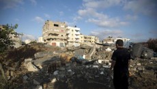 This Palestinian man overlooks the damages following a night of Israeli air strikes on July 3, 2014 in Gaza. (Photo: AFP - Mohammed Abed)