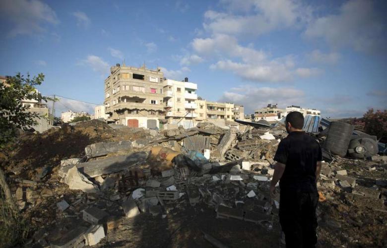 This Palestinian man overlooks the damages following a night of Israeli air strikes on July 3, 2014 in Gaza. (Photo: AFP - Mohammed Abed)